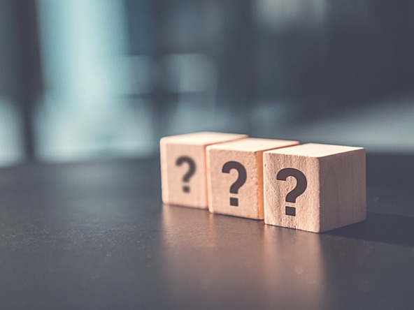 Three wooden blocks with question marks on them